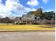 Charming two-story home with a manicured lawn and inviting red front door at 200 Suffolk Way, Mcdonough, GA 30252