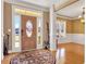 Elegant foyer featuring hardwood floors, a decorative rug, and a front door with glass accents at 200 Suffolk Way, Mcdonough, GA 30252