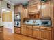 View of kitchen featuring wooden cabinets, granite countertops, and stainless steel appliances at 200 Suffolk Way, Mcdonough, GA 30252