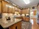 Kitchen with wood cabinets, granite countertops, stainless steel appliances, and tile backsplash at 200 Suffolk Way, Mcdonough, GA 30252