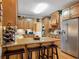 Well-lit kitchen with wooden cabinets, granite countertops, stainless steel appliances, and island seating at 200 Suffolk Way, Mcdonough, GA 30252