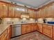 Kitchen featuring wooden cabinets, granite countertops, stainless steel sink, and tile backsplash at 200 Suffolk Way, Mcdonough, GA 30252