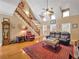An open living room with a high ceiling, windows for natural light and an area rug on the hardwood floors at 200 Suffolk Way, Mcdonough, GA 30252