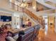 Spacious living room with wood staircase, high ceilings, hardwood floors and a large flat screen TV at 200 Suffolk Way, Mcdonough, GA 30252