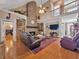 Beautiful living room with stone fireplace, high ceilings, wood floors, built-in bookshelves and modern decor at 200 Suffolk Way, Mcdonough, GA 30252