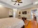 Comfortable main bedroom featuring a tray ceiling, hardwood floors and a view into the ensuite bathroom at 200 Suffolk Way, Mcdonough, GA 30252