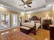 Bright main bedroom offers hardwood floors, a tray ceiling, and large windows for ample natural light at 200 Suffolk Way, Mcdonough, GA 30252
