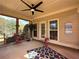 Cozy screened porch with a ceiling fan, comfortable seating, and outdoor views at 200 Suffolk Way, Mcdonough, GA 30252