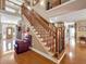 Interior view of a home featuring wood staircase, high ceilings, and hardwood floors with an inviting entrance at 200 Suffolk Way, Mcdonough, GA 30252