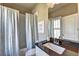 Elegant bathroom with a shower and tub combination featuring modern sink and cabinet at 2872 Evanshire Ave # 116, Duluth, GA 30096