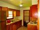 Kitchen with wooden cabinets, double sink, and appliances at 5542 Joeclay Dr, Stone Mountain, GA 30088