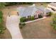 Aerial front view shows property on landscaped lot, with large driveway at 1030 E Lakehaven Way, Mcdonough, GA 30253