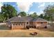 Brick home exterior features a back patio, deck, and fire pit area for outdoor enjoyment at 1030 E Lakehaven Way, Mcdonough, GA 30253