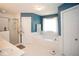Bright bathroom boasts a soaking tub, separate shower, and is decorated with a soothing blue hue at 1030 E Lakehaven Way, Mcdonough, GA 30253