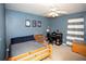 Comfortable bedroom featuring a ceiling fan, study desk, and ample storage space at 1030 E Lakehaven Way, Mcdonough, GA 30253