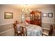 Formal dining room with chandelier, decorative china cabinet, and six chairs at 1030 E Lakehaven Way, Mcdonough, GA 30253