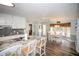 Modern kitchen with granite countertops, bar seating, and adjacent dining area at 1030 E Lakehaven Way, Mcdonough, GA 30253