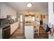 Open concept kitchen showcasing granite counters, a center island, and seamless flow into the sunlit breakfast nook at 1030 E Lakehaven Way, Mcdonough, GA 30253