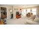 A living room offers a cozy couch, TV setup, and plenty of natural light at 1030 E Lakehaven Way, Mcdonough, GA 30253