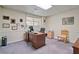 Carpeted basement office featuring a large desk, computer and natural light from the window at 4423 Windsor Oaks Cir, Marietta, GA 30066