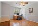 Comfortable bedroom with hardwood floors, ceiling fan, and a large window at 4423 Windsor Oaks Cir, Marietta, GA 30066