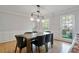 Elegant dining room with hardwood floors, stylish lighting, and wainscoting detail at 4423 Windsor Oaks Cir, Marietta, GA 30066