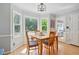 Dining room featuring bay windows, wood floors, neutral color scheme and light fixture at 4423 Windsor Oaks Cir, Marietta, GA 30066