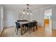 Modern dining room featuring hardwood floors, wainscoting, and stylish pendant lighting at 4423 Windsor Oaks Cir, Marietta, GA 30066