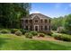 Traditional two-story brick home with mature landscaping and a well-manicured lawn at 4423 Windsor Oaks Cir, Marietta, GA 30066