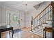 Bright foyer with hardwood floors, staircase, elegant lighting, and detailed trim work at 4423 Windsor Oaks Cir, Marietta, GA 30066
