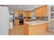 Bright kitchen featuring wood cabinets, black appliances, and breakfast bar with seating at 4423 Windsor Oaks Cir, Marietta, GA 30066