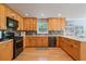 Traditional-style kitchen with wooden cabinets, black appliances and light countertops at 4423 Windsor Oaks Cir, Marietta, GA 30066