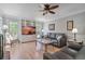 Comfortable living room featuring a brick fireplace, built-in shelving, and large windows at 4423 Windsor Oaks Cir, Marietta, GA 30066