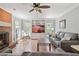 Inviting living room featuring a cozy brick fireplace, built-in shelves and large windows at 4423 Windsor Oaks Cir, Marietta, GA 30066