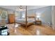 Serene main bedroom with four-poster bed, hardwood floors, and ample natural light at 4423 Windsor Oaks Cir, Marietta, GA 30066