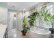 Elegant bathroom featuring a soaking tub, shower, and large window at 502 Allgood Ne Rd, Marietta, GA 30060