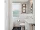 Bathroom with a dark tile floor, white walls, modern lighting, toilet and sink at 502 Allgood Ne Rd, Marietta, GA 30060