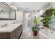 Elegant bathroom featuring a soaking tub, shower, and double vanity at 502 Allgood Ne Rd, Marietta, GA 30060