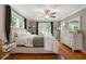 Cozy bedroom with hardwood floors, large windows, and ceiling fan at 502 Allgood Ne Rd, Marietta, GA 30060