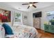 Well-lit bedroom with hardwood floors, two large windows, a flat screen tv and a large bed at 502 Allgood Ne Rd, Marietta, GA 30060