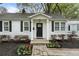 Charming home with a welcoming front door, stone walkway, and beautiful flower beds at 502 Allgood Ne Rd, Marietta, GA 30060