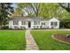 Charming home featuring a stone walkway, green lawn, and a quaint front exterior at 502 Allgood Ne Rd, Marietta, GA 30060