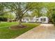 Traditional home with mature landscaping including a beautiful tree and green lawn at 502 Allgood Ne Rd, Marietta, GA 30060