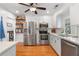 Modern kitchen with stainless steel appliances, light countertops, and open shelving at 502 Allgood Ne Rd, Marietta, GA 30060