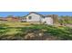 Exterior view featuring white siding, a walkout basement, and a sprawling yard at 6684 Birch Rd, Winston, GA 30187