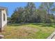 Fenced backyard with lawn and mature trees offers shade and privacy at 6684 Birch Rd, Winston, GA 30187