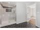 Stylish bathroom with hexagon tile, glass enclosed shower, and access to the bedroom at 6684 Birch Rd, Winston, GA 30187