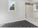 Modern bathroom showcasing a glass shower with decorative tile and a window at 6684 Birch Rd, Winston, GA 30187