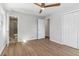 Bright bedroom featuring a ceiling fan, light gray walls and wood-look flooring at 6684 Birch Rd, Winston, GA 30187