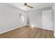 Bedroom featuring light-colored wood floors, a window and a fan at 6684 Birch Rd, Winston, GA 30187
